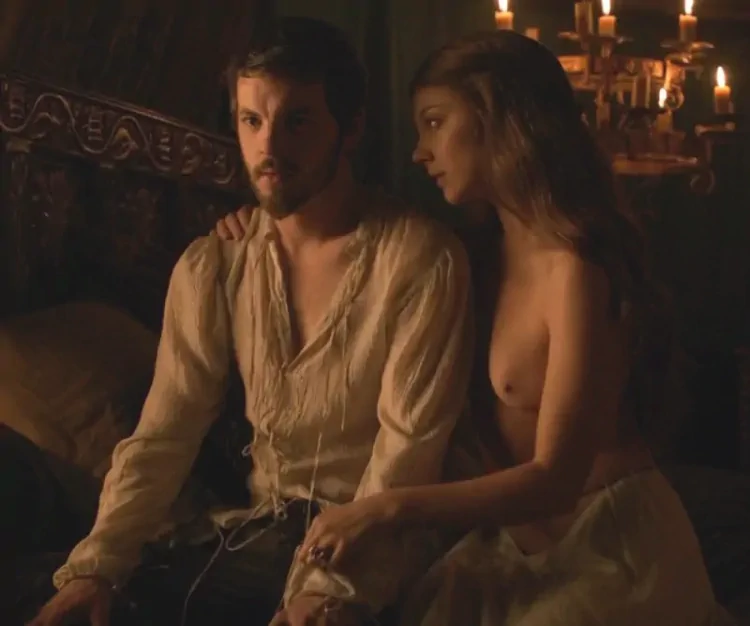 natalie sitting on bed topless with breasts exposed in game of thrones