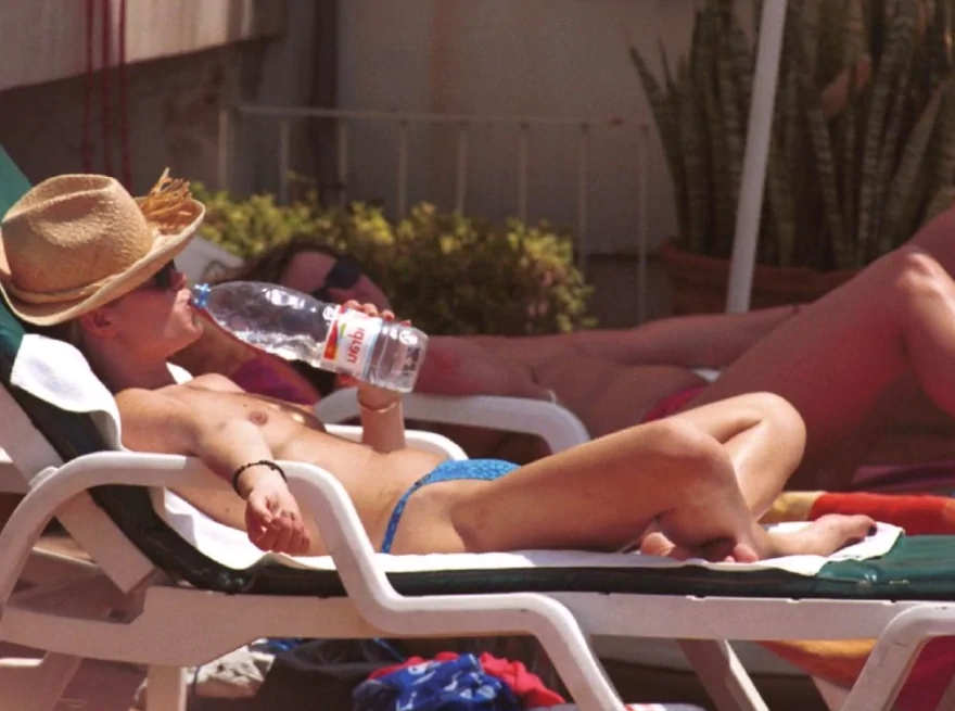 amanda holden drinking from water bottle while nude sunbathing