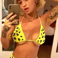 rita ora boob spill in yellow bikini