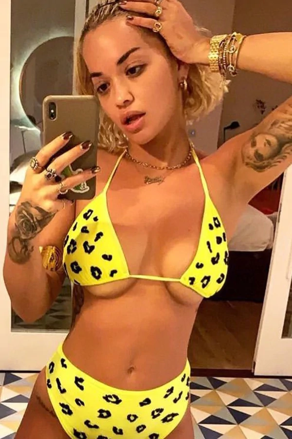 rita ora boob spill in yellow bikini